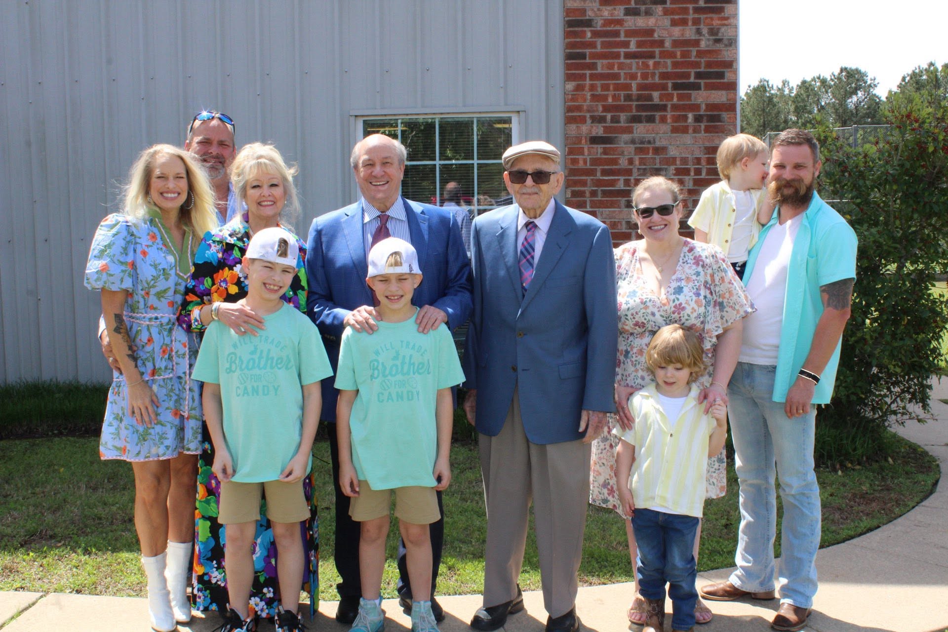 Families gathered outside the church on a sunny day